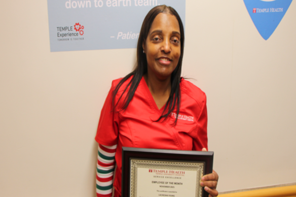 Patient Care Assistant Lacresha Young with her Service Excellence Employee of the Month Award.