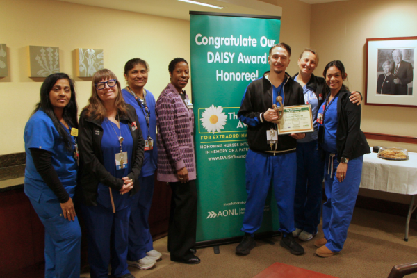 Paul Micenec (center right) celebrates his DAISY Award with his colleagues and leadership.