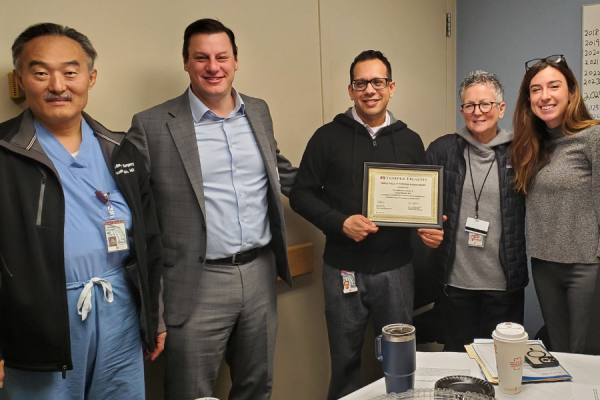 Dr. Mokashi (center) receives his TFP Kudos Award from Dr. Stein (second from left), Amy J. Goldberg, MD, FACS, The Marjorie Joy Katz Dean of the Lewis Katz School of Medicine (second from right), and Claire Raab, MD, President & CEO of TFP (far right). Also pictured is Yoshiya Toyoda, MD, PhD, Chief of Cardiovascular Surgery at Temple University Hospital (far left). 