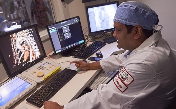 Temple cardiologist looking at x ray on computer