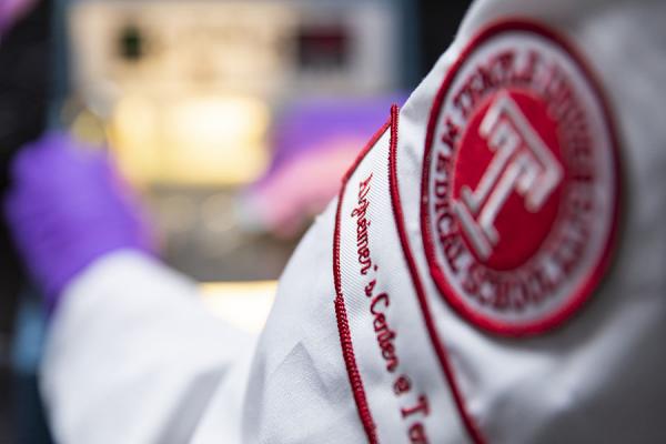 Temple Alzheimer's Research Center badge on a lab coat