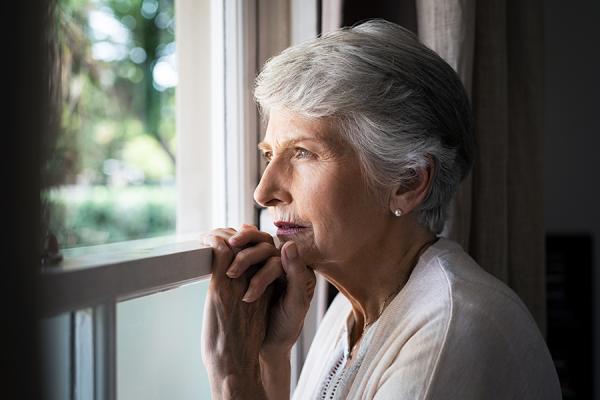 Older woman looking out the window